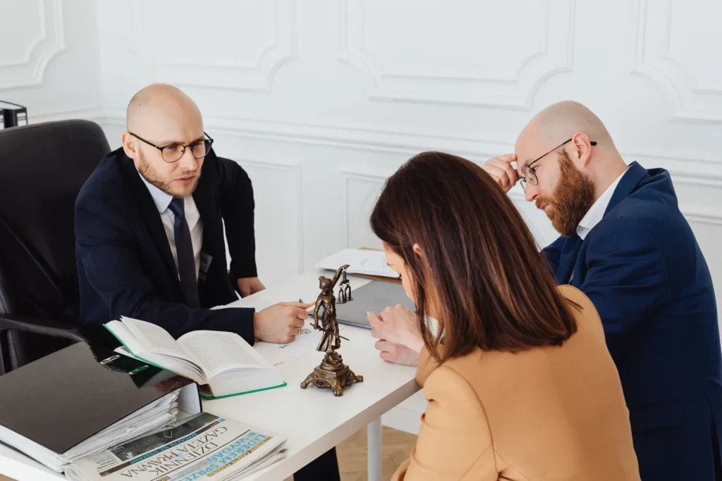 Attorney reviewing documents with clients in an office