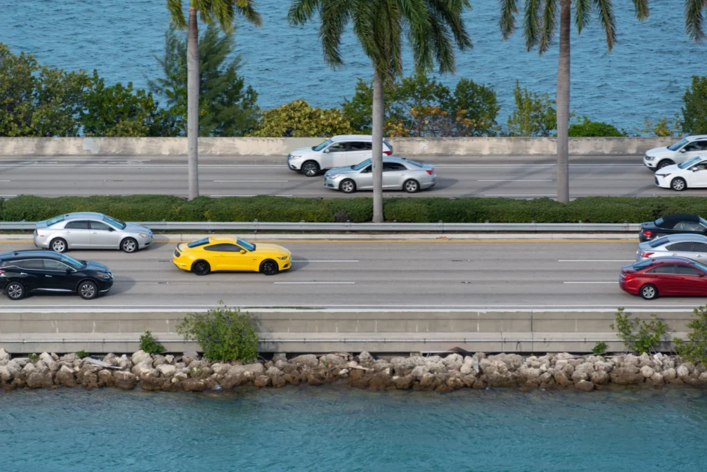 Cars on a Florida coastal highway lined with palm trees