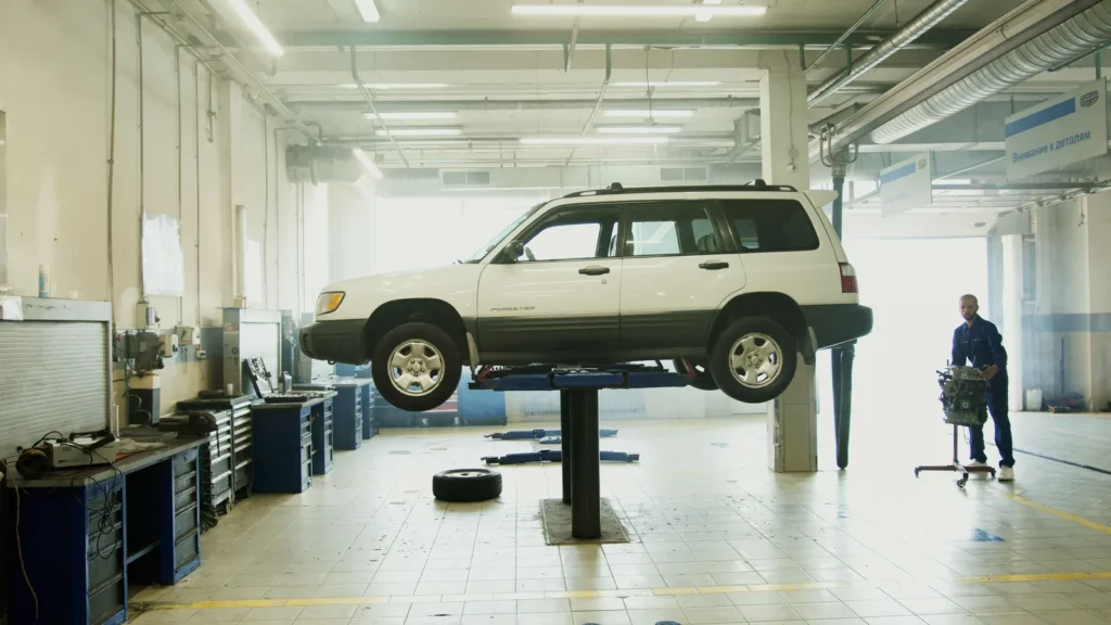 Vehicle raised on a lift in a repair shop