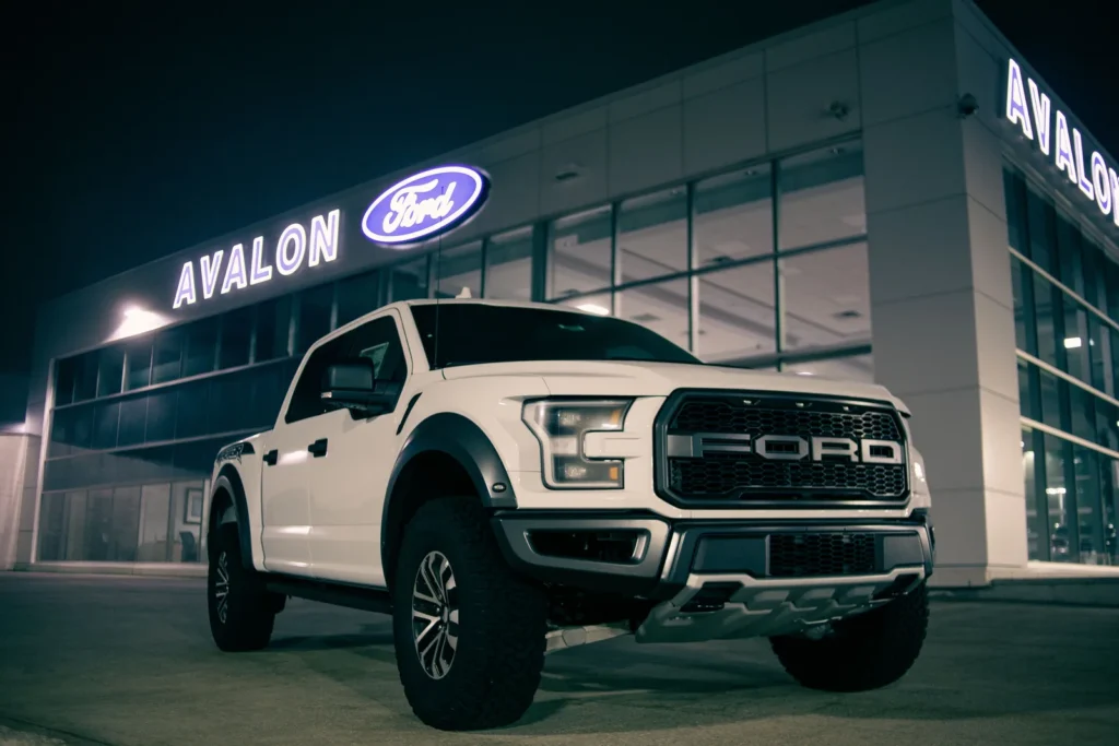 Pickup truck parked outside a dealership at dusk