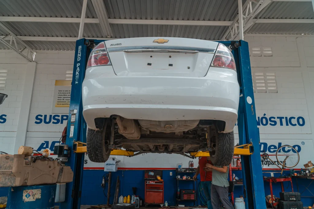 Vehicle raised on a shop lift during a repair visit